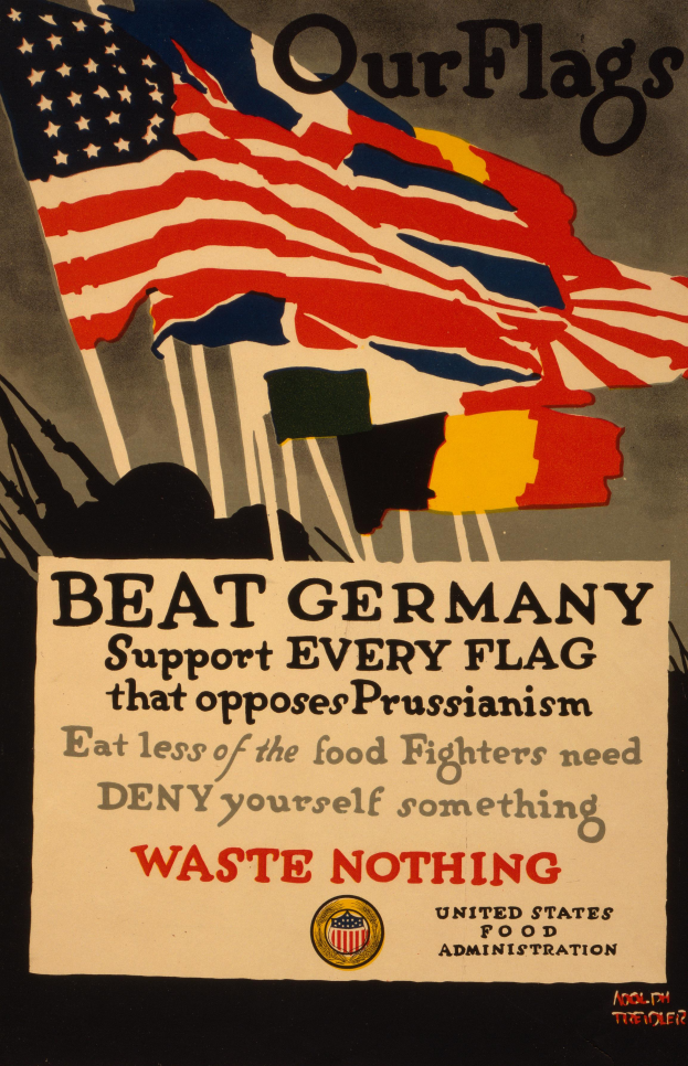 Ein Plakat mit einer roten, weißen und blauen Flagge mit einem weißen Stern, begleitet von fettem schwarzem Text, der "Unsere Flaggen schlagen Deutschland - Unterstützt jede Flagge, die gegen Preußentum kämpft", mit einem weißen Rand um den Text.