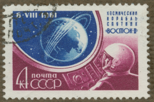 Eine Briefmarke mit einem Mann im Weltraumanzug mit entschlossener Miene, umgeben von der fett gedruckten Textzeile "Marke" in weißer Schrift.