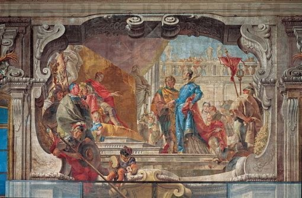 Ein lebendiger und detaillierter Fresko auf einer Decke, das eine Gruppe von Menschen, Skulpturen und Gegenstände in einer Mischung aus traditioneller und moderner Kleidung zeigt, realistisch dargestellt.