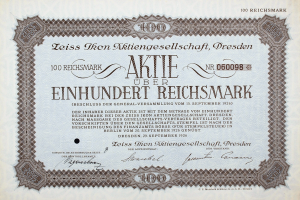 Ein altes deutsches Aktienzertifikat mit schwarzem Rand und der Inschrift "Aktie über Einhundert Reichmark"