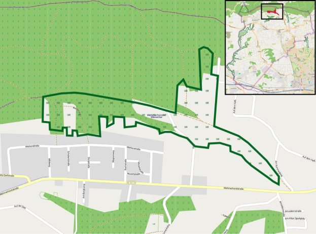 Stadtplan mit markierter Lage des geplanten Standorts in Grün, Straßen, Gebäude und andere städtische Merkmale.