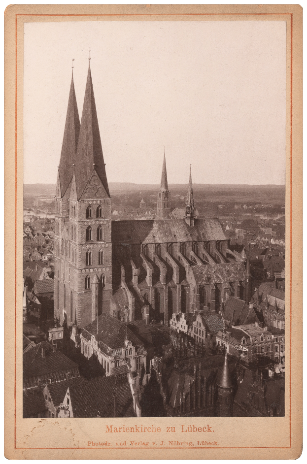 Ein altes Foto einer Stadt mit einer Kirche in der Mitte, umgeben von anderen Gebäuden, und Text unten.