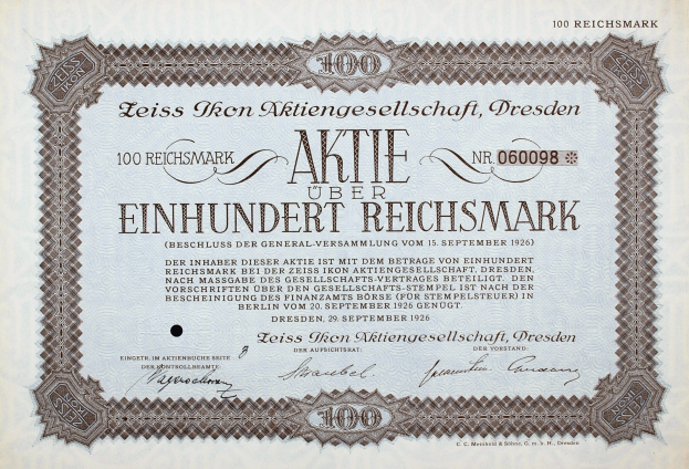 Altes deutsches Aktienzertifikat über 100 Reichsmark mit schwarzem Rand und gedrucktem Text.