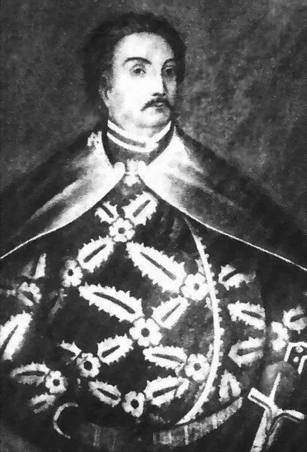 Schwarzes und weißes Foto von Papst Johannes Paul II. in Priesterroben, der eine schwarze Robe mit weißem Kragen und Manschetten trägt und die Hände verschränkt hält, mit einem strengen Gesichtsausdruck und direktem Blick.